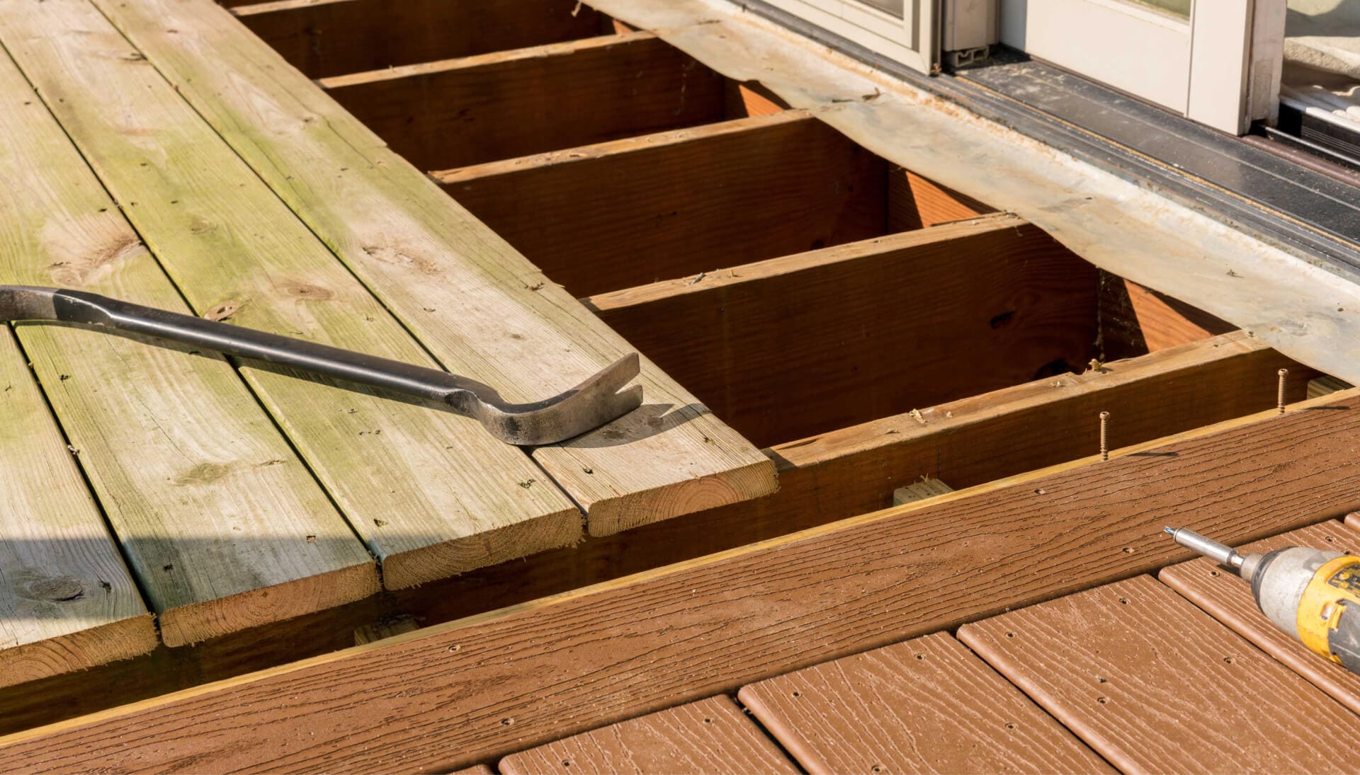 Skilled deck builders in Columbia, Missouri, performing expert deck repair services to restore the safety and beauty of a damaged deck.