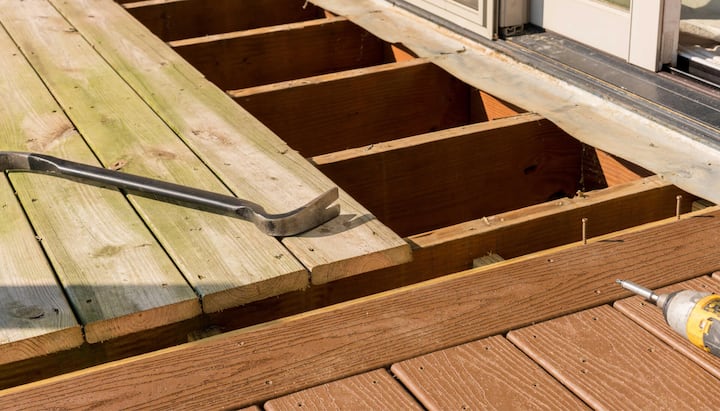 Skilled deck builders in Columbia, Missouri, performing expert deck repair services to restore the safety and beauty of a damaged deck.